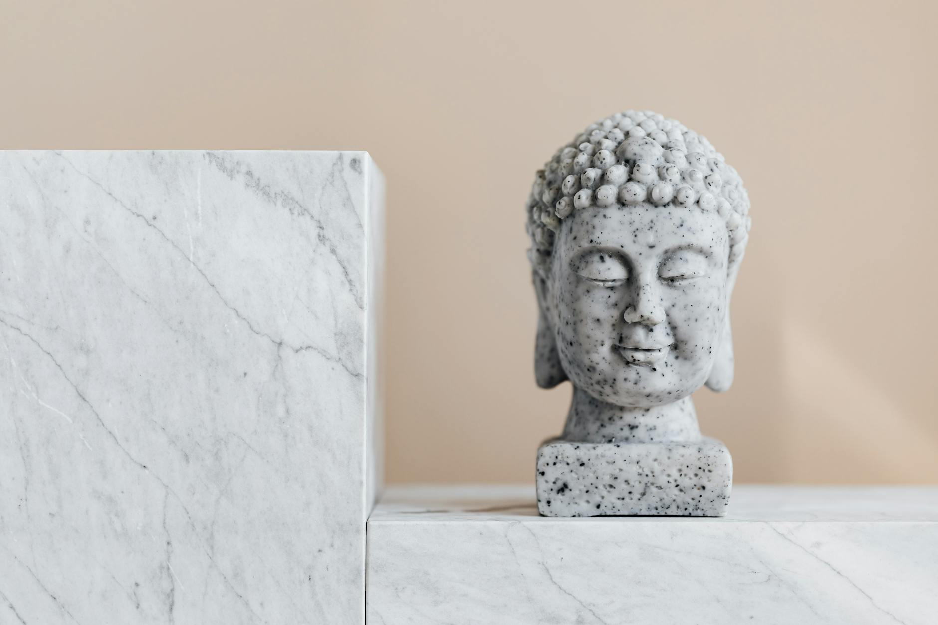 traditional stone buddha statue on marble shelf