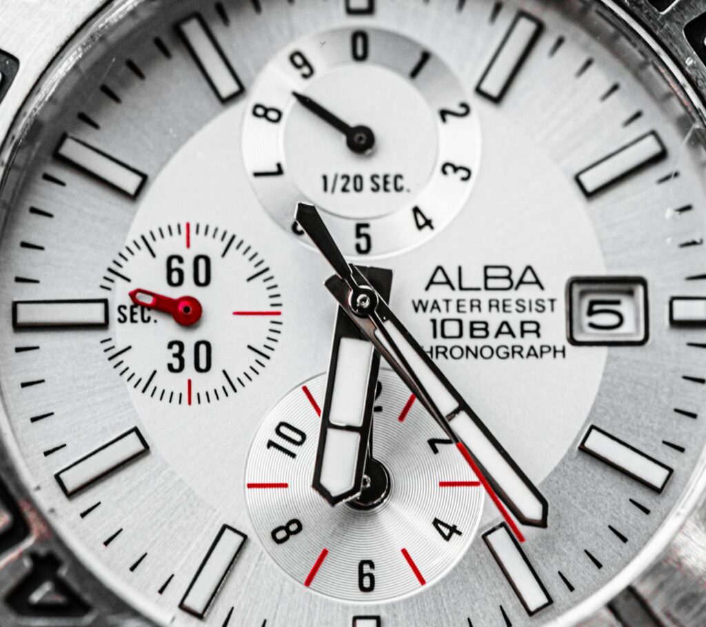 silver and black round analog watch