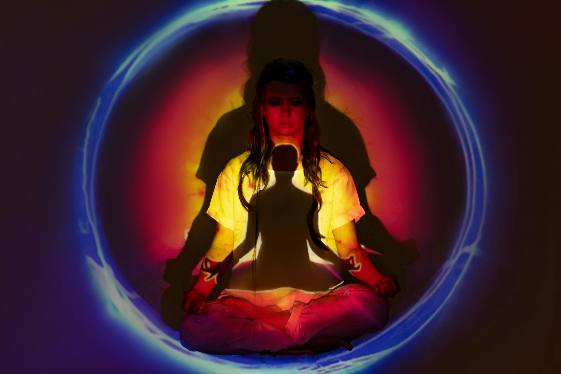 woman in yellow jacket and blue denim jeans sitting on blue round inflatable ring